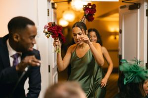 Party guests laughing and enjoying drinks at a formal event.