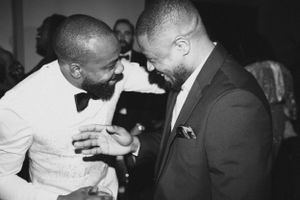 Two guests share joyful moment during wedding celebration.