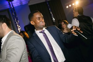 Guest enjoying himself while dancing at a formal evening event.