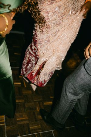 Close-up of sparkly formal dress at dancing event.