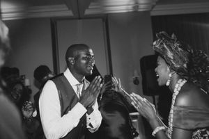 Guests share an energetic dance moment on the dance floor at a formal event.