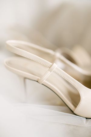 Close-up of cream colored bridal heel showing delicate stitching details.
