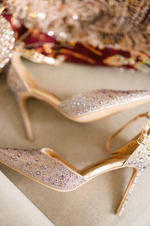 Glittering champagne-colored stiletto heels with crystal embellishments.