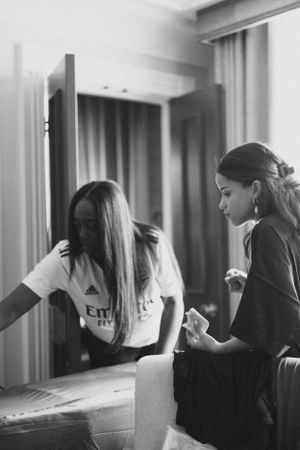 Black and white candid moment captured in a hotel room interior.