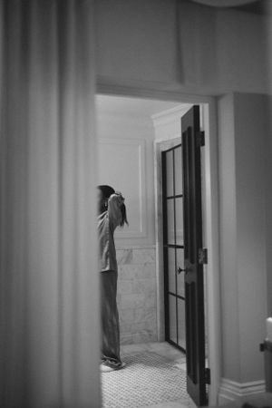 Black and white photograph of a silhouette standing in a doorway.