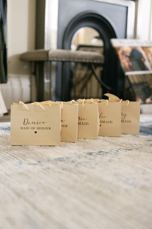 Row of elegant cream-colored name cards for bridesmaids and maid of honor.