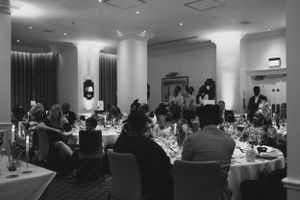 Wedding reception dinner party in elegant hotel banquet room.