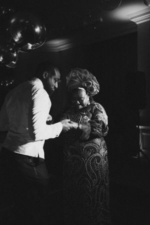 Black and white photo of a couple dancing at an elegant evening event.