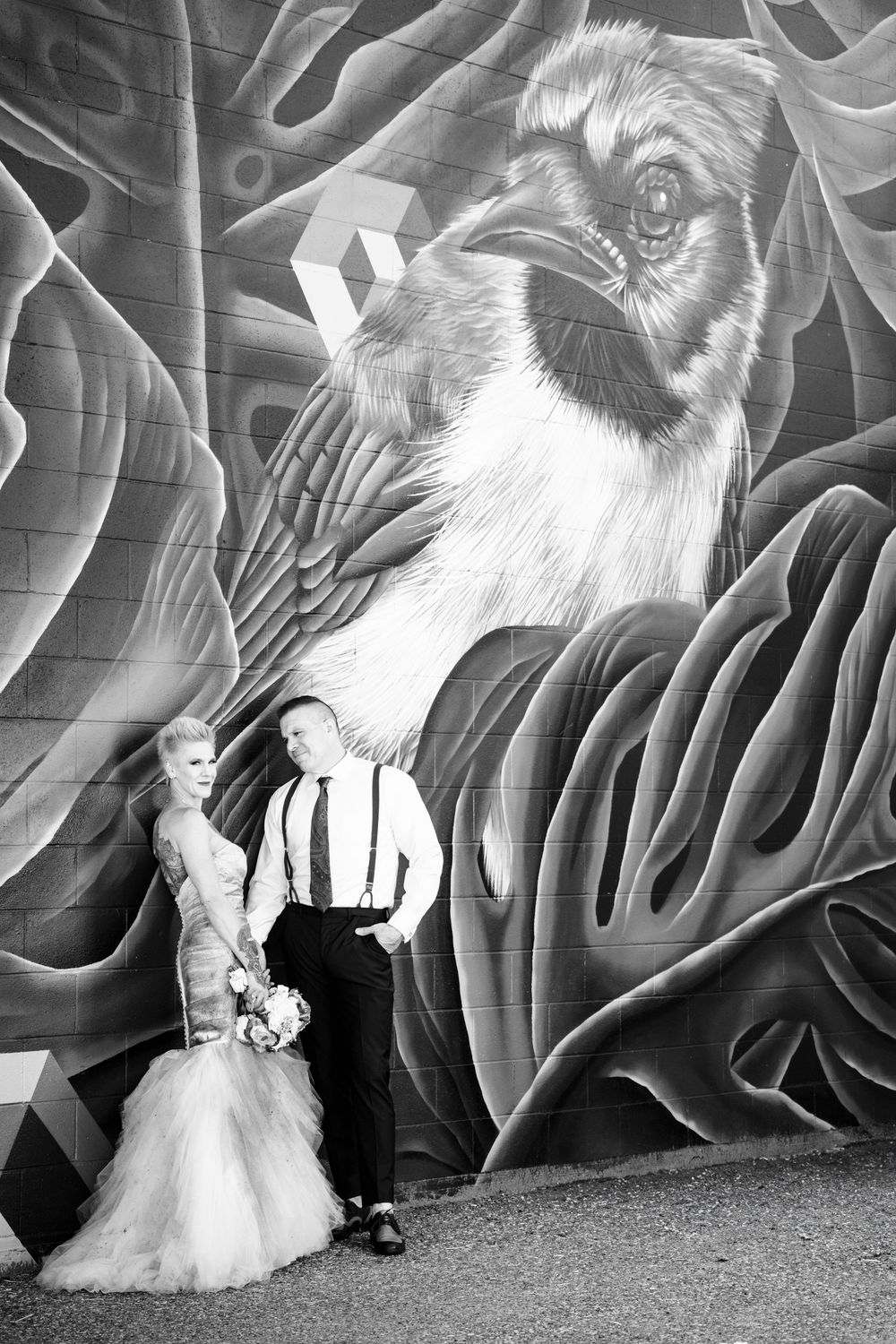 Black and white photo series showing a white cat sitting against a dramatic wavy patterned wall background.