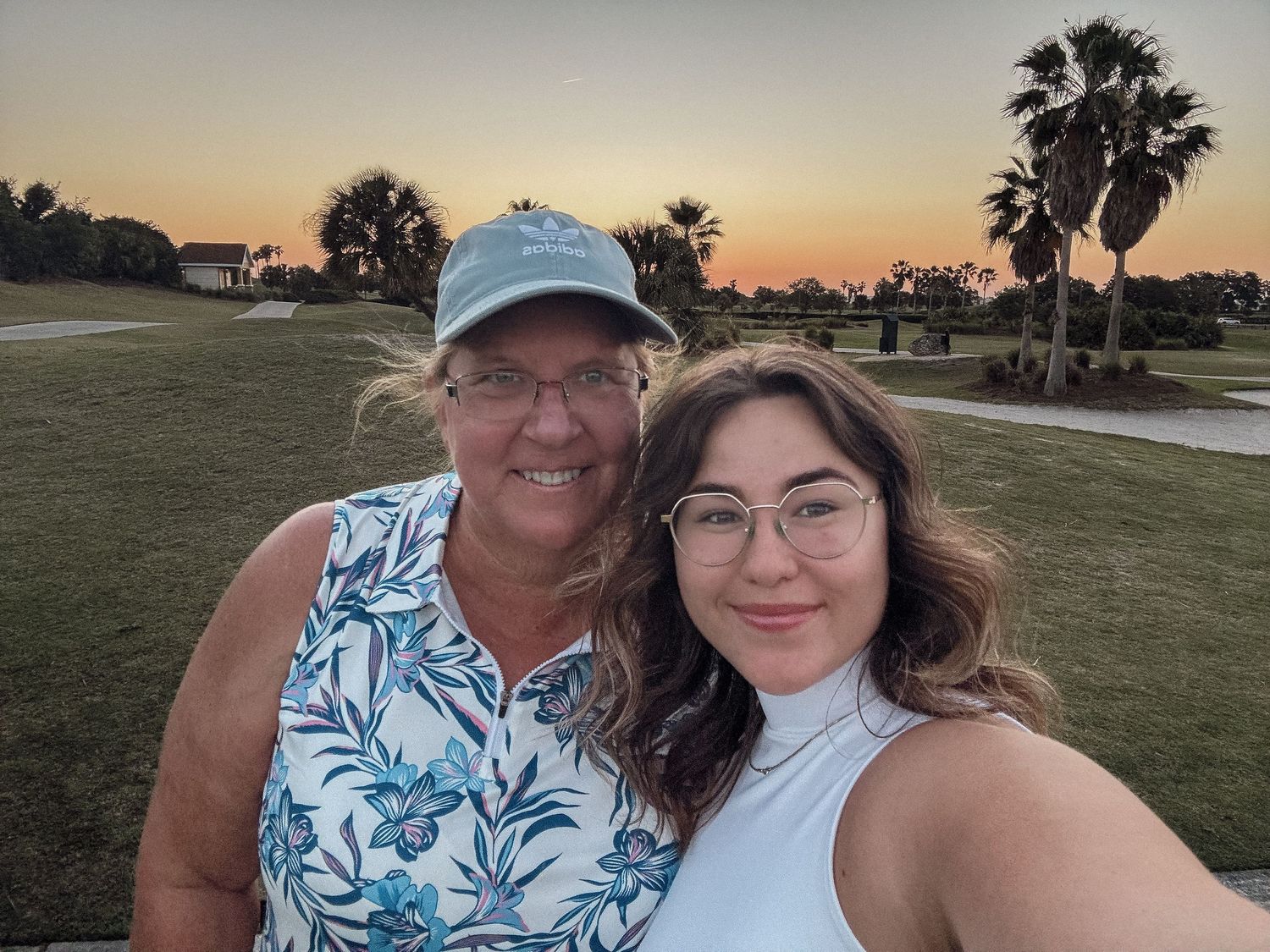 Sunset gathering at a beachside location with palm trees in the background.