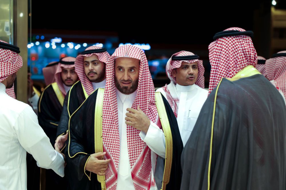 لحظة استقبال الضيوف في حفل الزفاف بالرياض، حيث يقف عائلة العريس في استقبال الحضور بابتسامات ودية.
