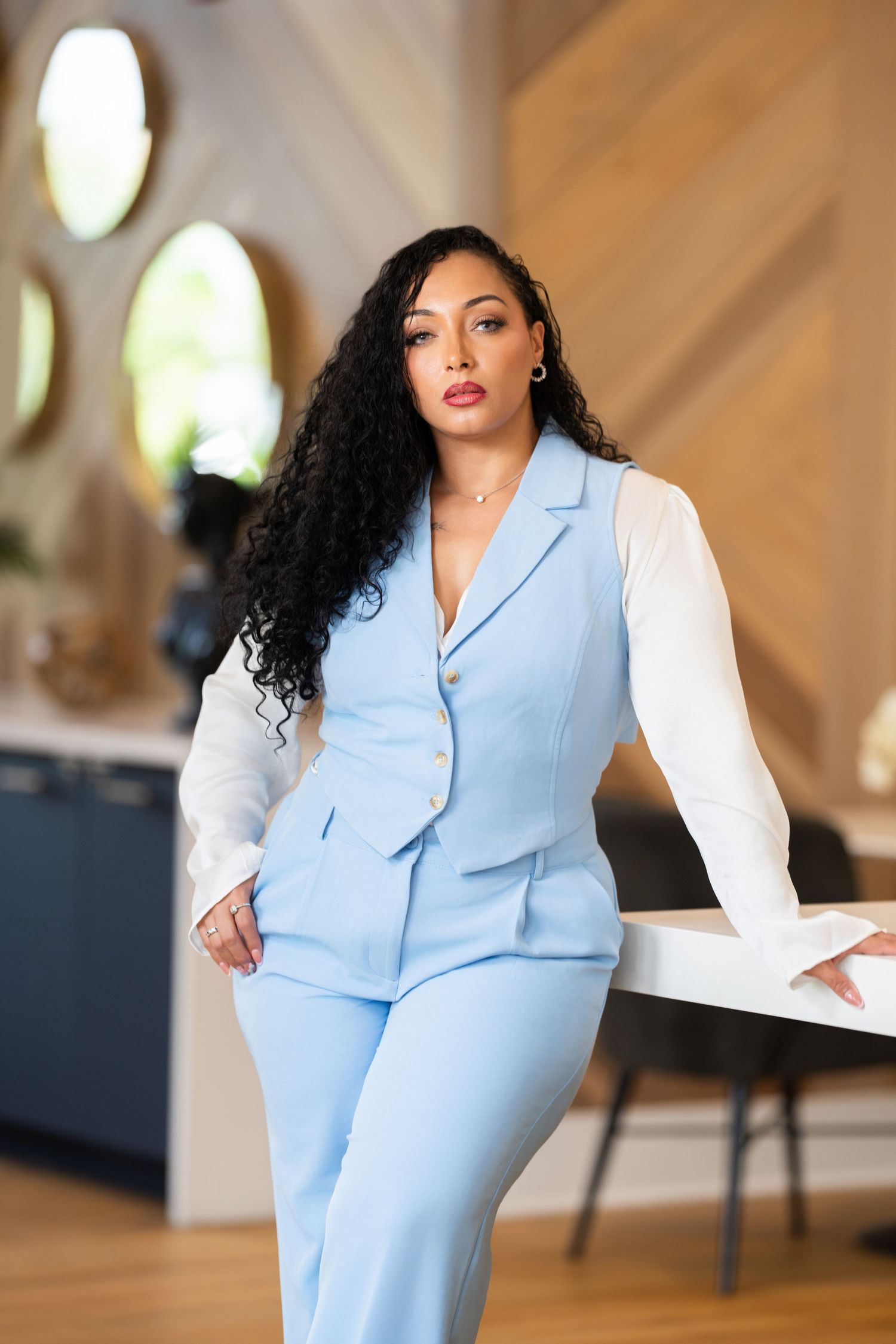 Professional fashion photo of a light blue fitted vest dress suit styled for contemporary business attire.