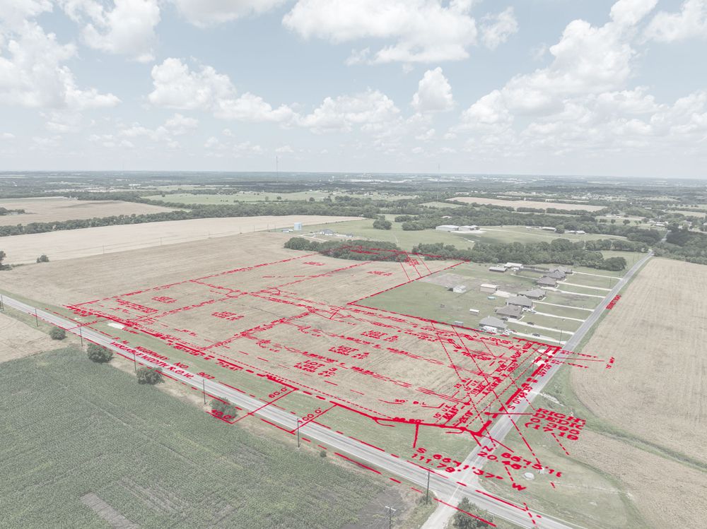 Aerial survey map showing property subdivision layout with red boundary lines.