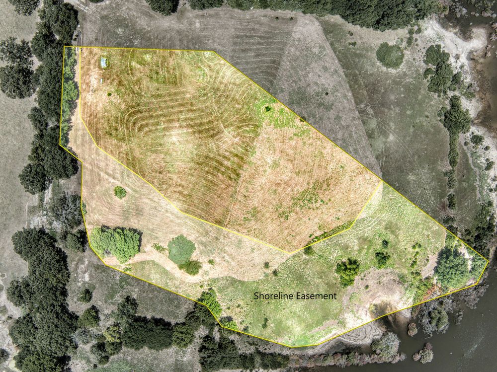 Satellite view of agricultural land showing terrain contours and vegetation patterns.