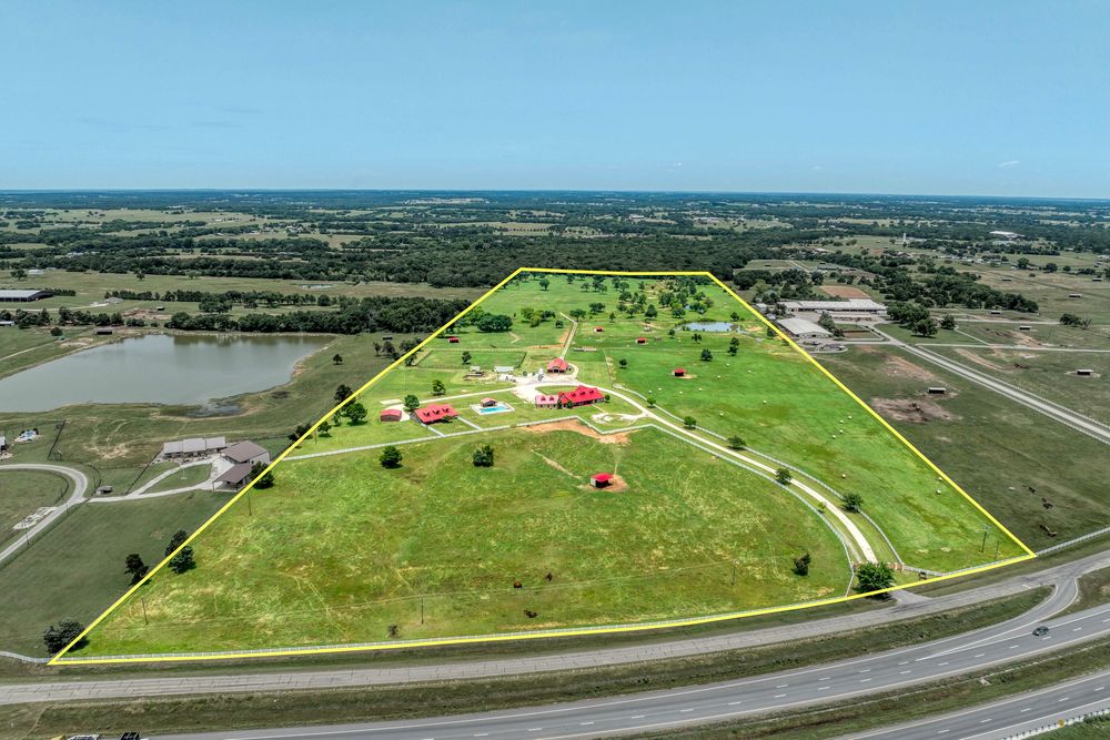 Aerial photography showing highway intersection with property parcels outlined in yellow.