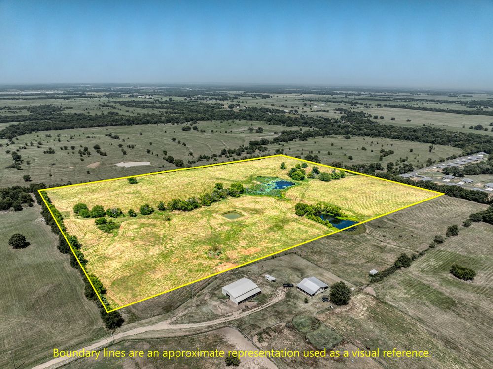 Aerial view of rural property with yellow highlighted boundaries showing land parcel.