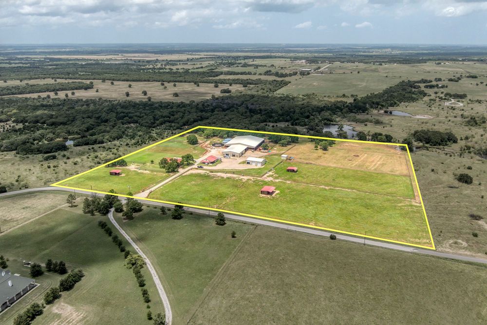Aerial view of rural farmland and property boundaries marked with yellow lines.