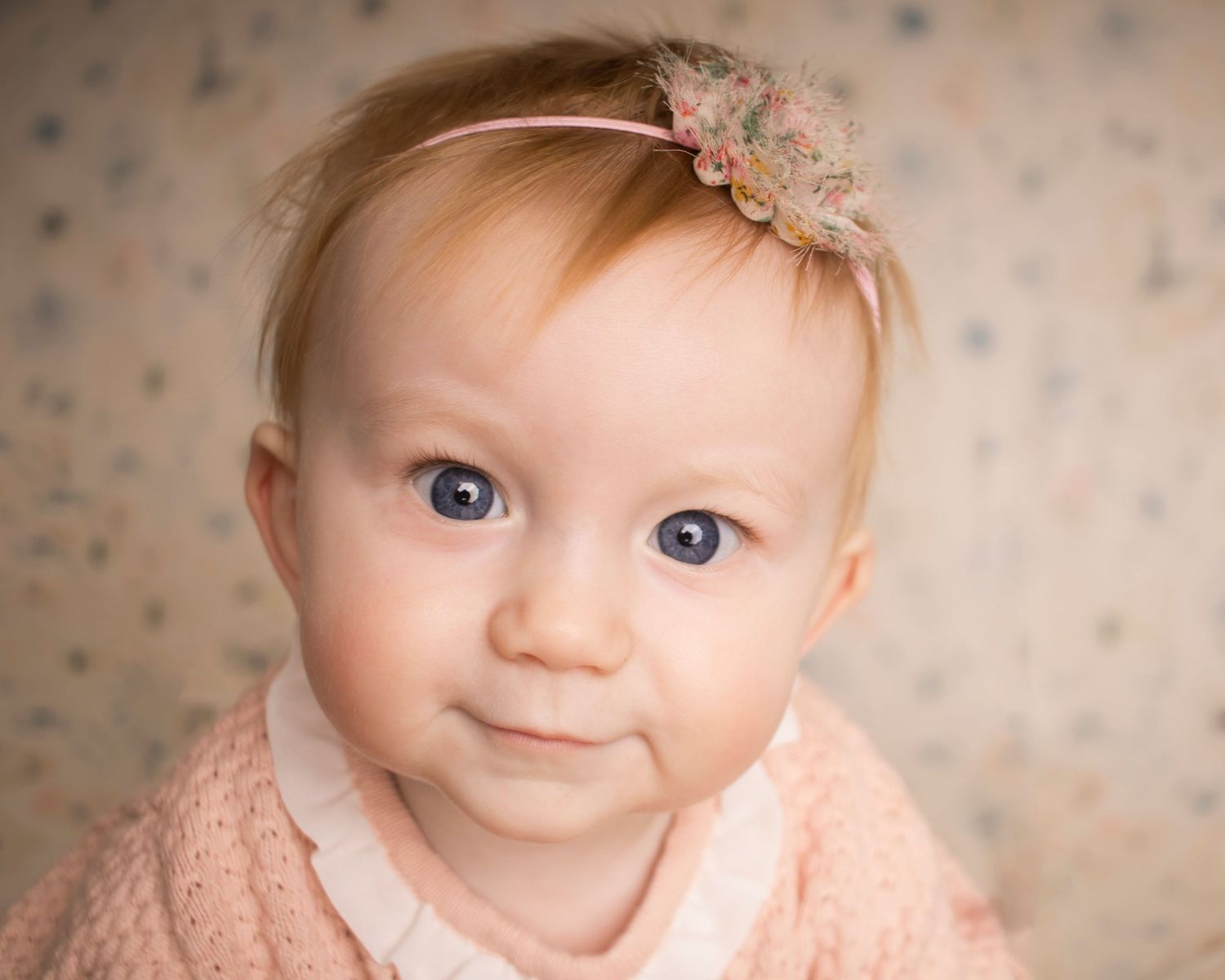 A baby girl looks at the camera