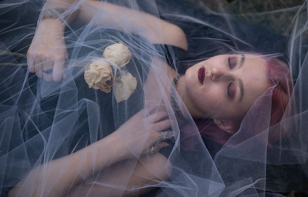 Teen girl holding dried roses under tulle gothic style, Williamston South Carolina