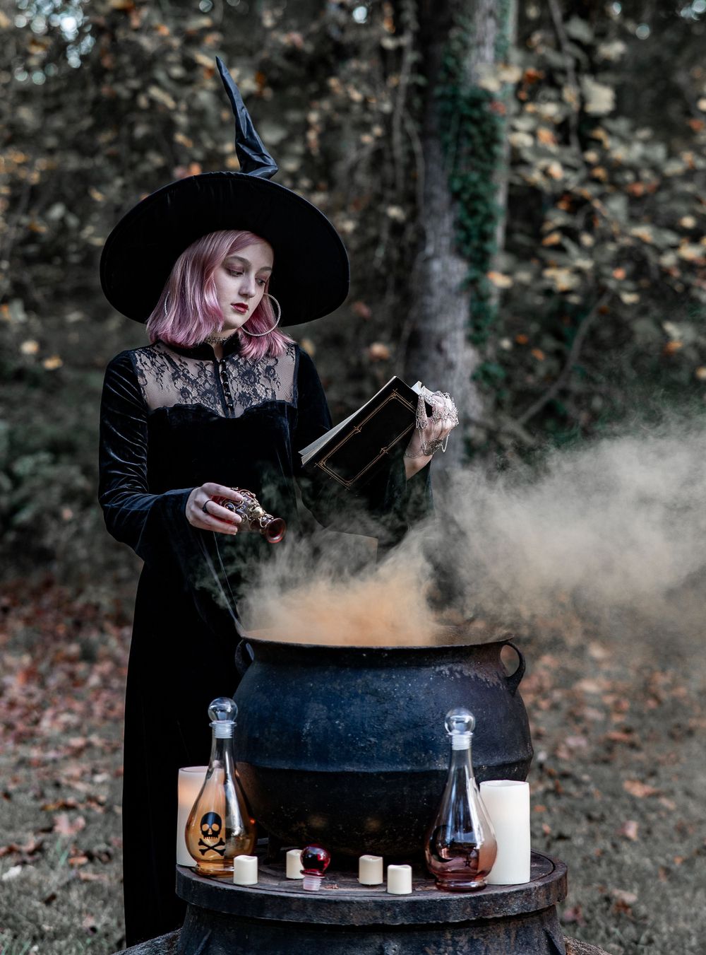 Teen witch in mixing her cauldron with a hat and orange smoke, Williamston South Carolina.