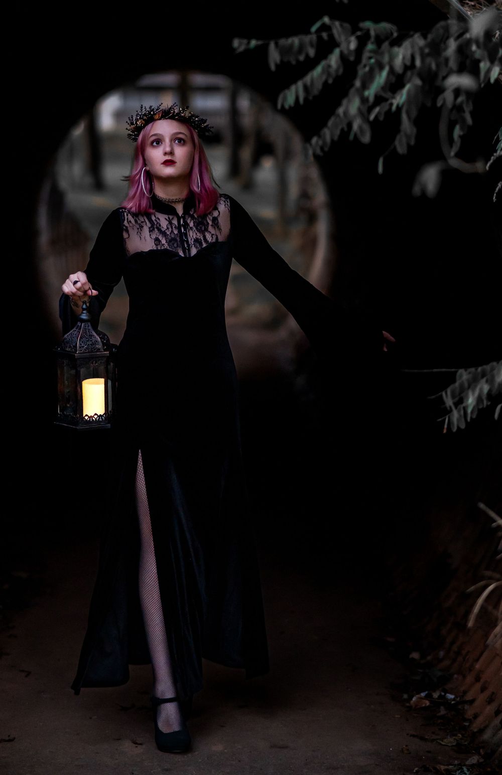 Teen girl holding lantern walking through tunnel, gothic style, Williamston South Carolina