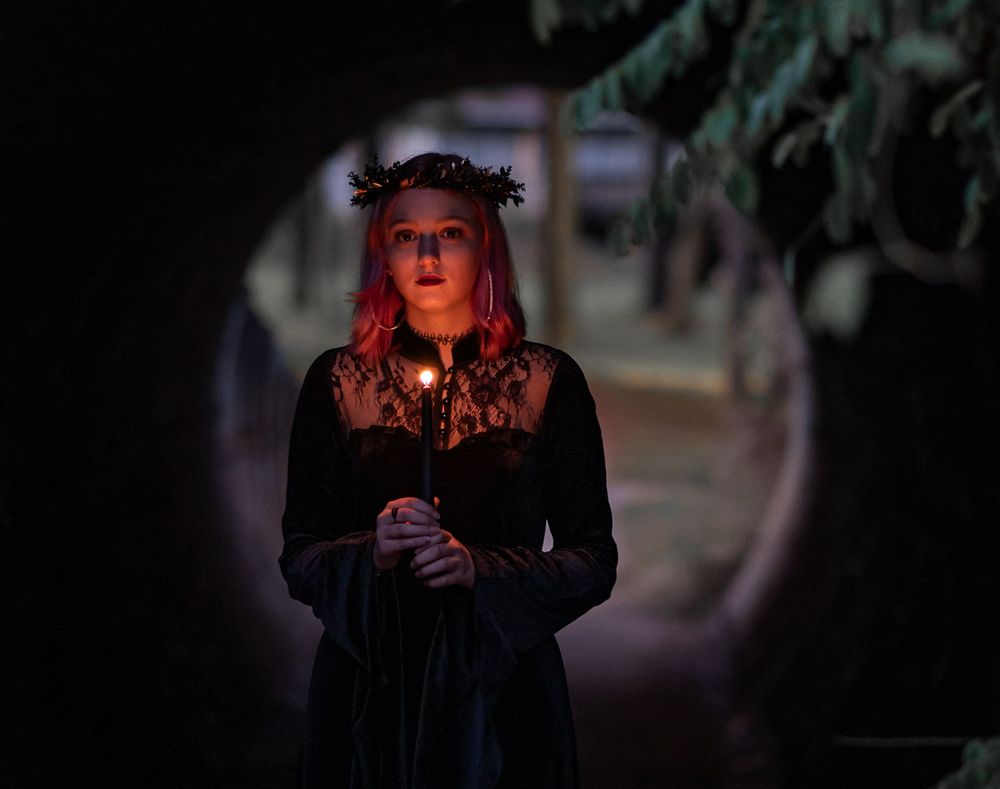 Teen girl holding candle in tunnel, gothic style, Williamston South Carolina