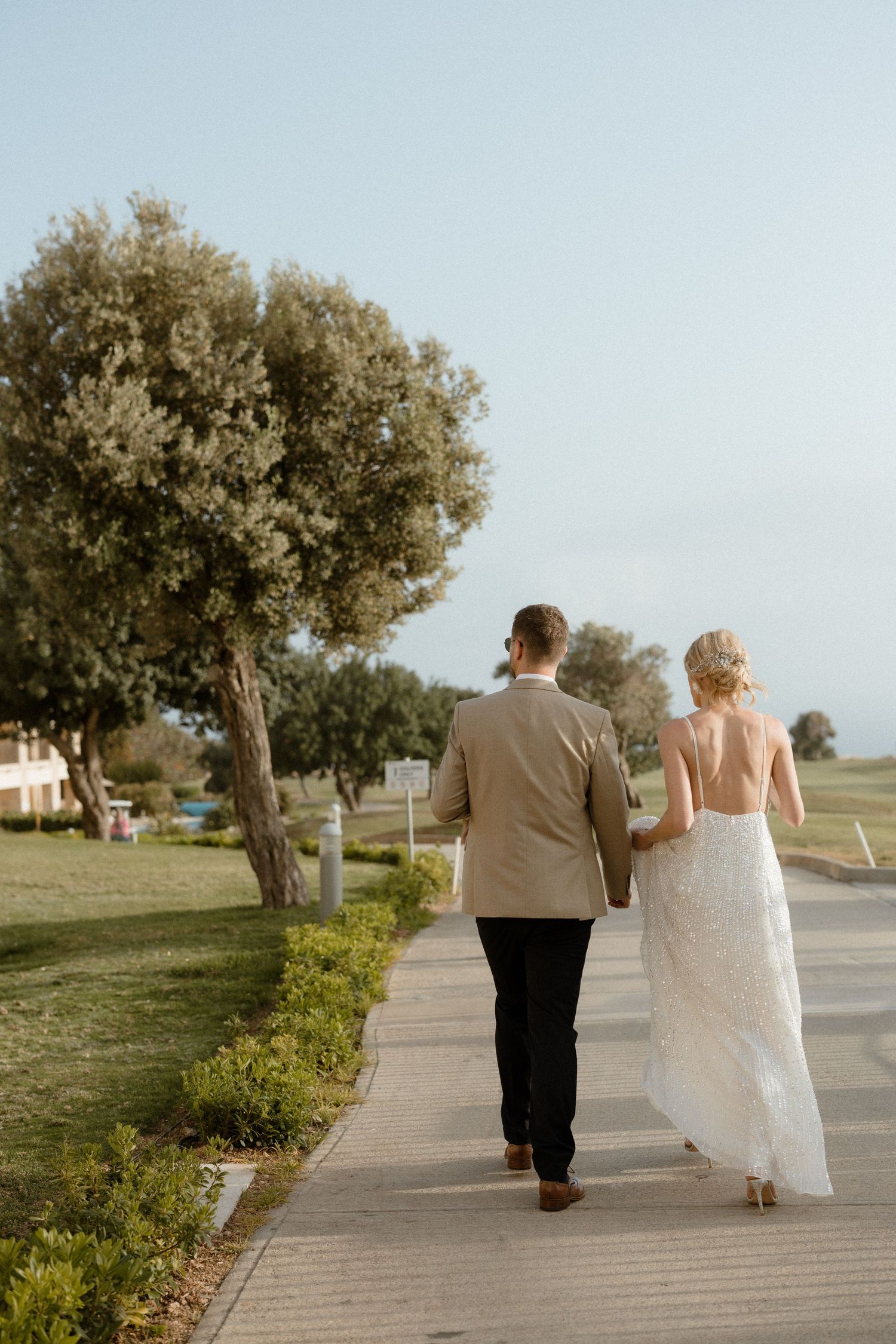 Couple walking during photoshoot in Cyprus while they are being photographed.