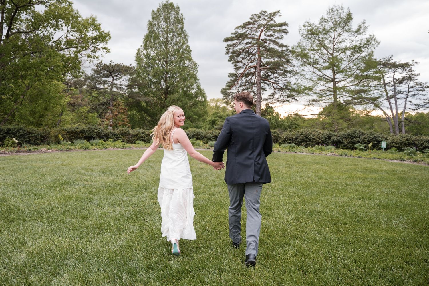 Couple sharing romantic moment in golden wildflower field at sunset.