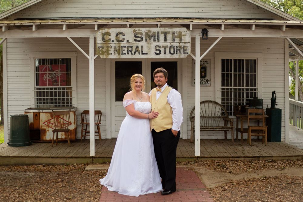 A wedding portrait in front of the historic C.C. Smith General Store building.