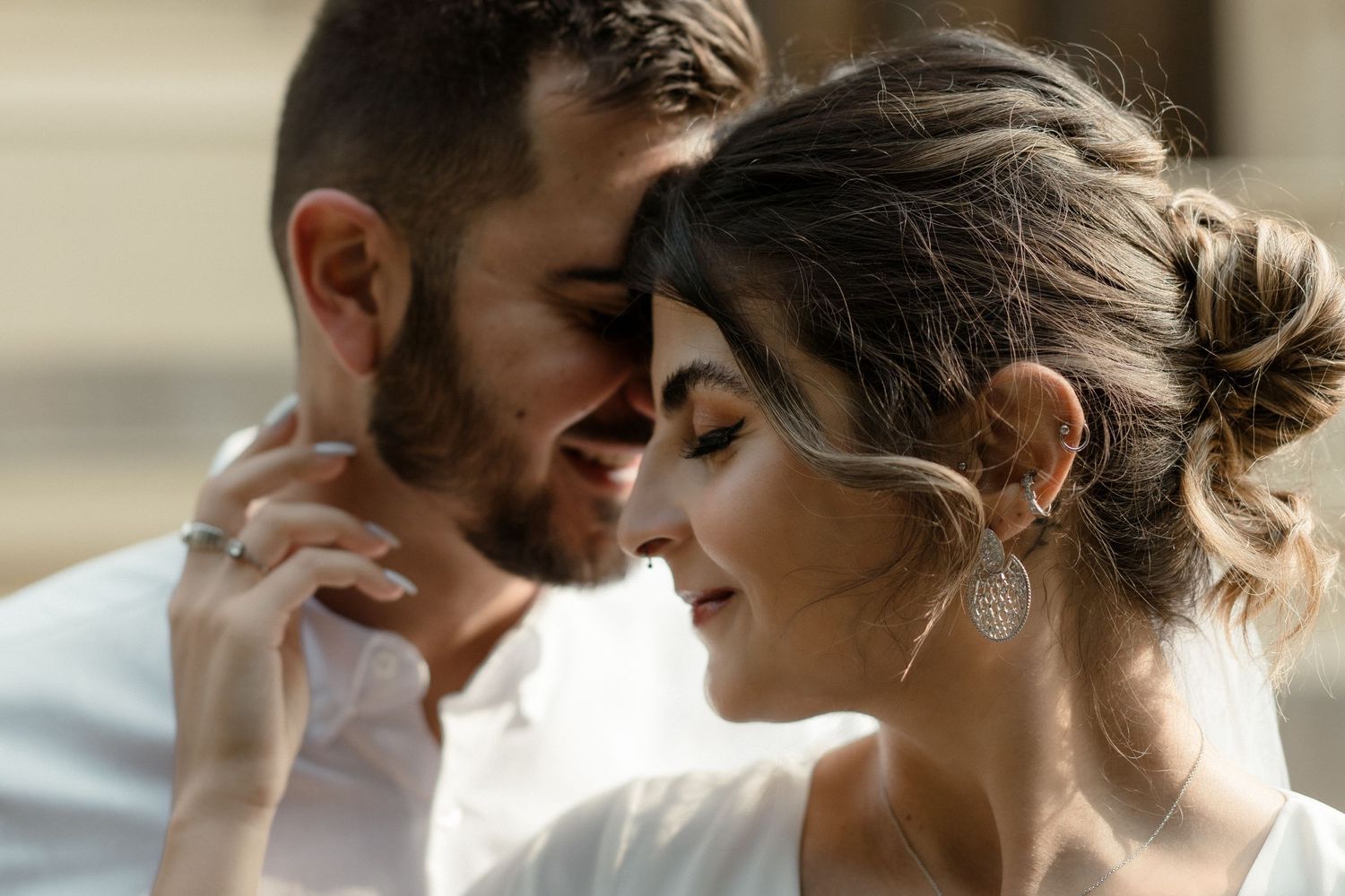 Intimate romantic moment between a couple in formal attire sharing a tender embrace.