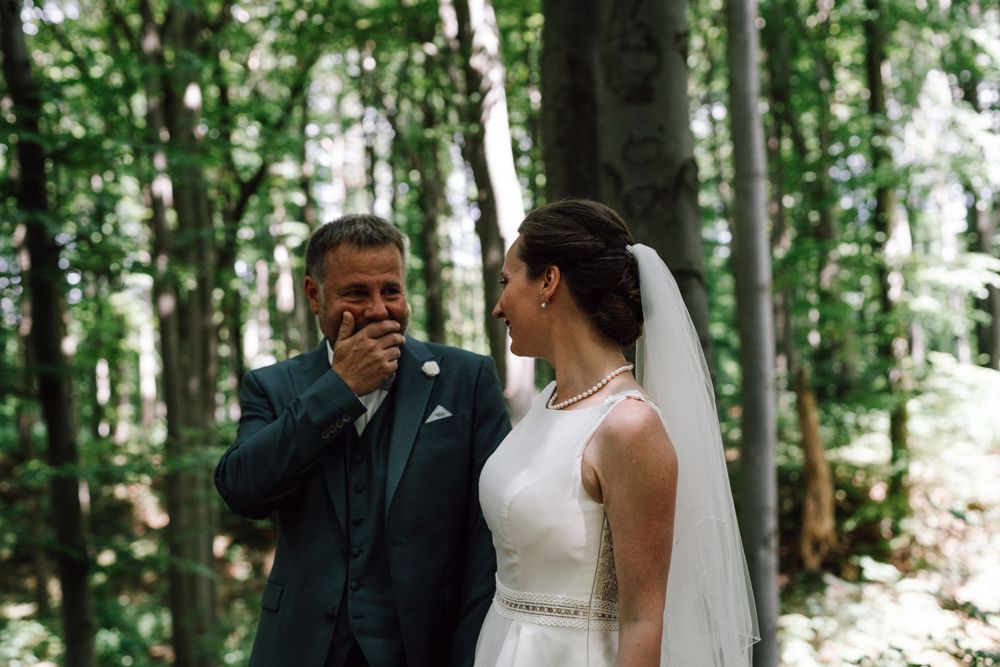 Romantic wedding portraits captured in a serene woodland setting.