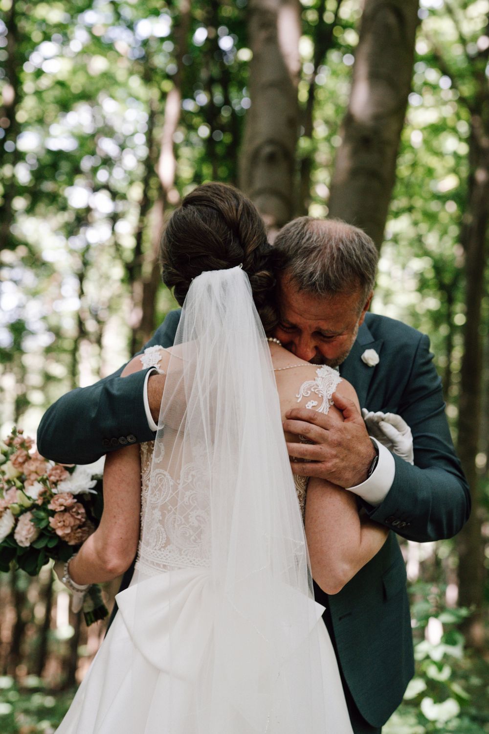 Emotional wedding moments captured in a beautiful forest setting.