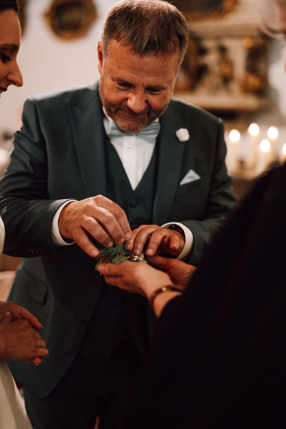Close-up shots of ring exchange during wedding ceremony.