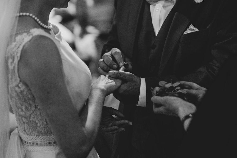 Black and white close-up of formal wedding attire details.