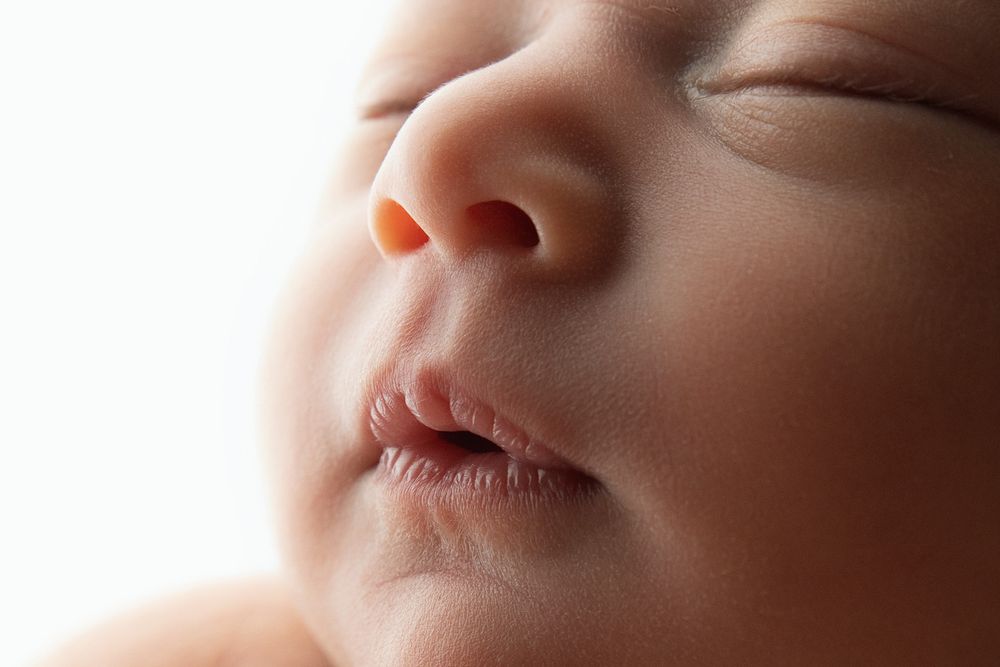 Close-up macro shots of baby facial features in soft lighting.