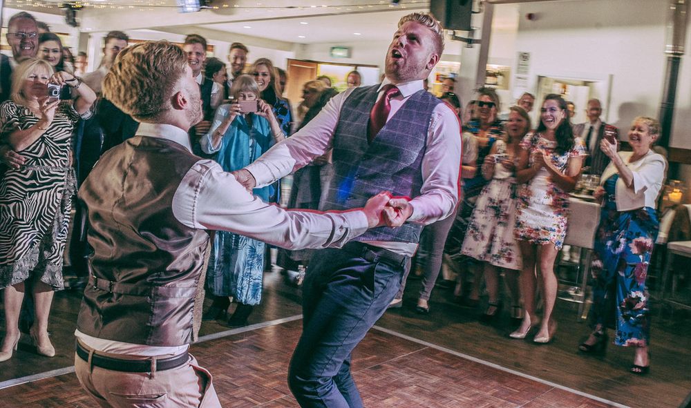 Two men dancing at their wedding at Ocean Kave