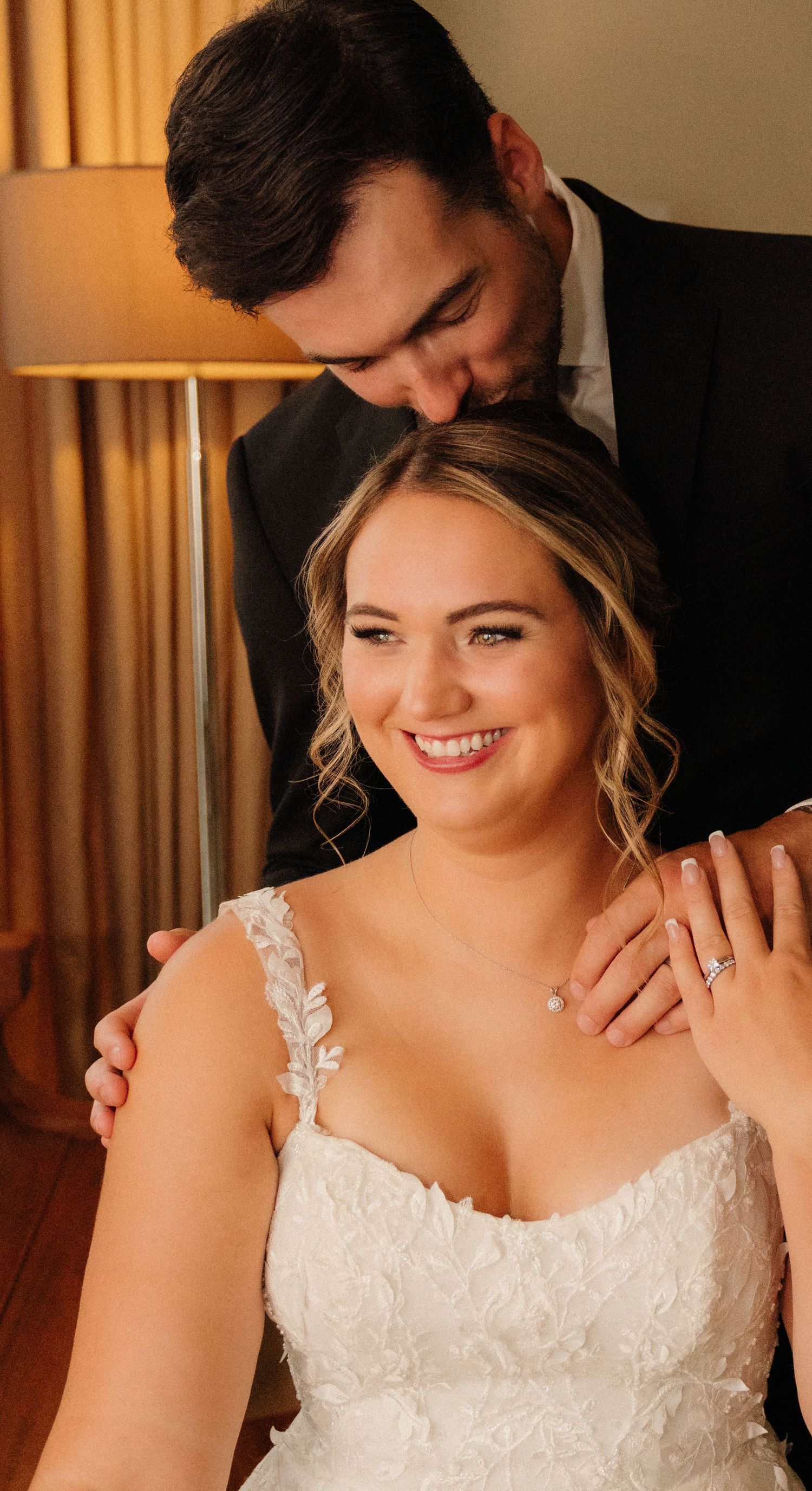 A romantic moment between newlyweds in formal attire.
