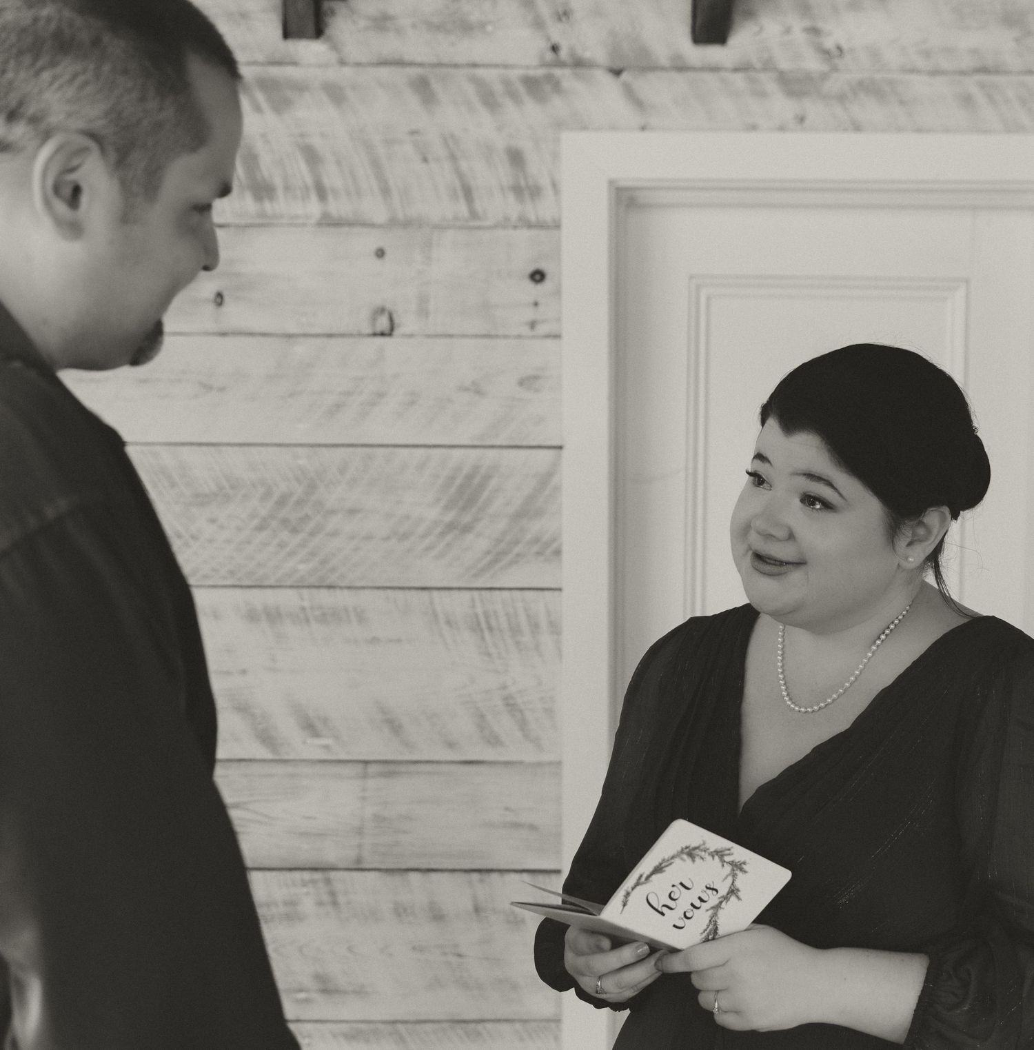 A couple looks at each other during what appears to be an intimate ceremony.