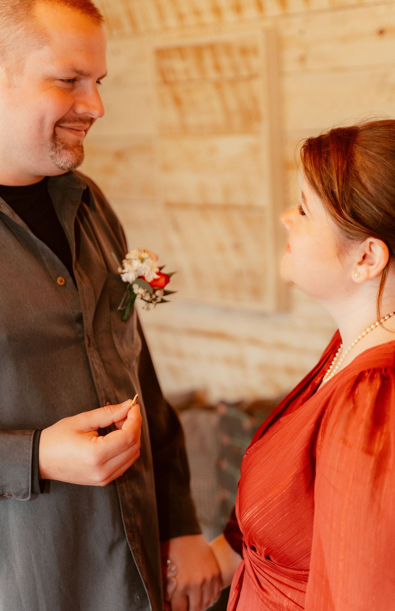 Two people share a tender moment during what appears to be a wedding ceremony.