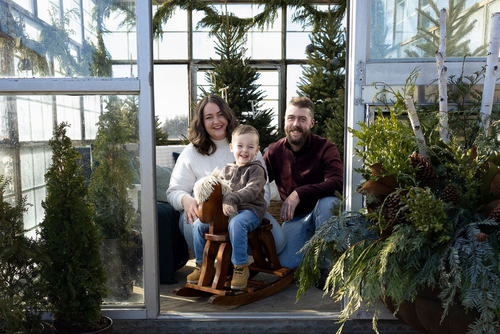 A collection of connected greenhouse or conservatory spaces filled with lush plants and natural light.