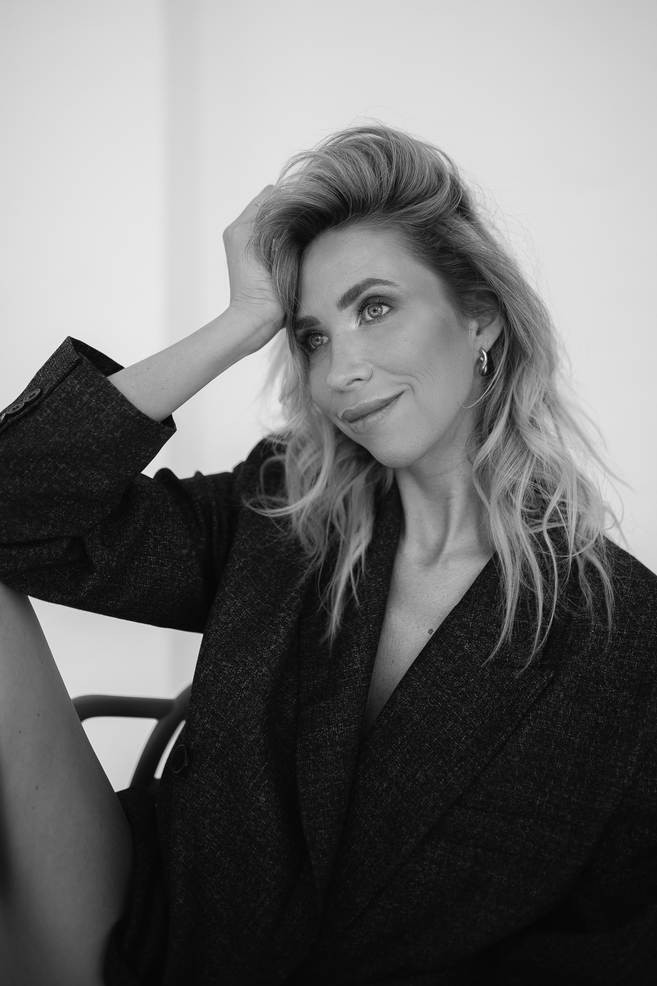 Artistic black and white fashion portrait of woman in oversized blazer.