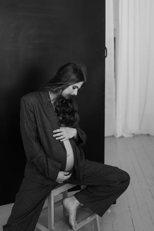 Dramatic black and white portrait series showing intimate poses in studio setting.