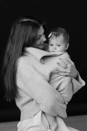 Black and white portrait series showing intimate bonding moments between parent and child.