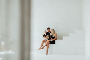 Minimalist family portrait series against white background showing movement and connection.