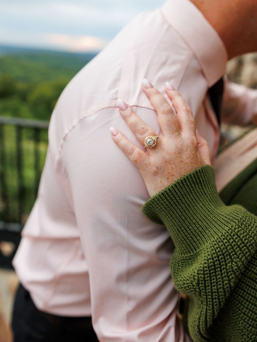 engagement ring at top of the rock with budget friendly photographer.