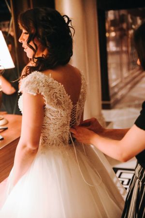 Detailed back of a lace wedding dress with delicate button closures.