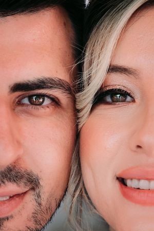 Close up portrait showing half faces with warm lighting and soft expressions.