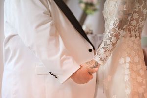 Wedding party preparations with bridesmaids in pink dresses and white robes getting ready in a sunlit room.