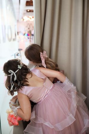 Three sequential photos show someone in a light pink ruffled dress dancing and twirling around gracefully.