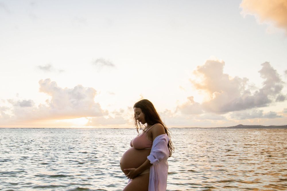 Pregnant model standing in the middle of the ocean.  Photograph was shot in Puerto Rico.